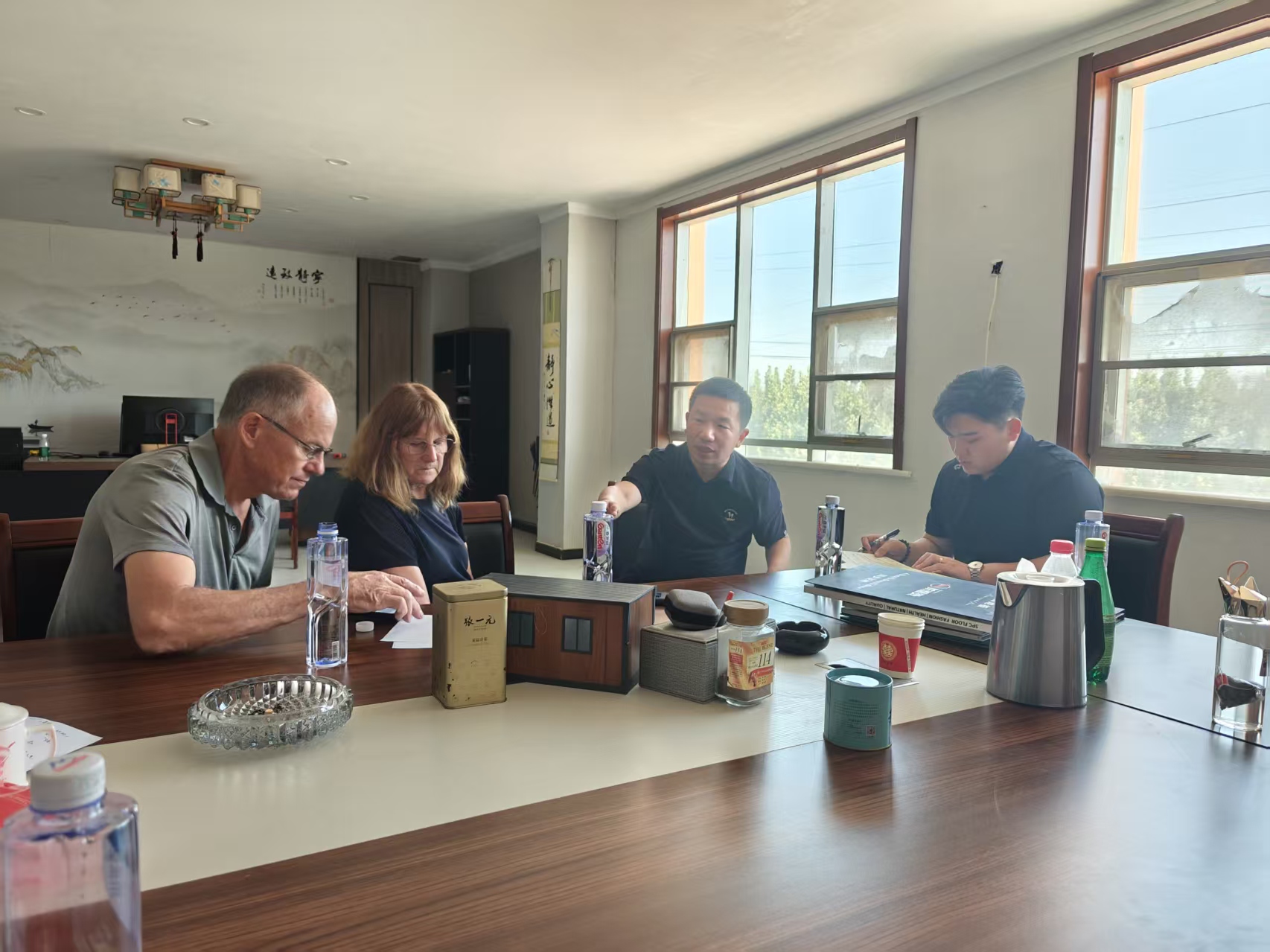 International customers reviewing prefab house model samples with the Feeker team in a meeting room